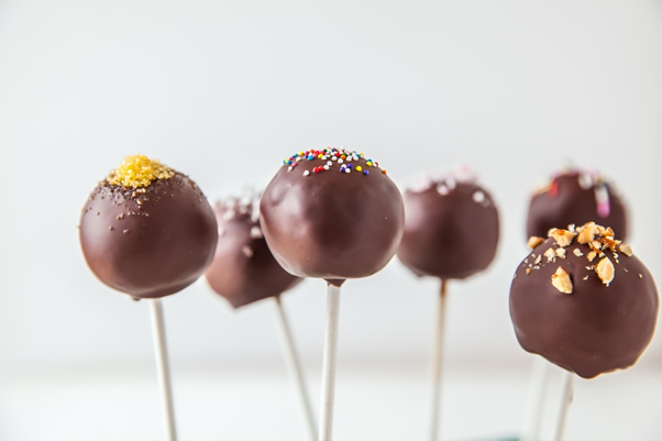 : Delicious cake pops coated in chocolate frosting and sprinkles