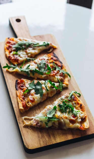 Garlic pizza with basil leaves 